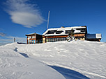 Die Hochrieshütte, links daneben das Gipfelkreuz