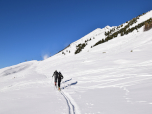 Über den flachen Hang queren wir die Piste und halten auf einen kleinen Schlepper zu