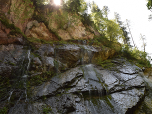 Links von uns plätschert das Wasser über die glatten Felsen